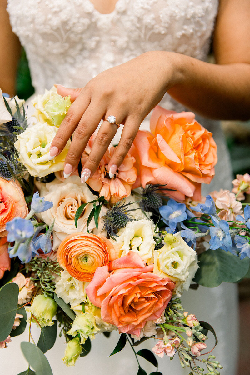 bride's engagement ring and and on flowers