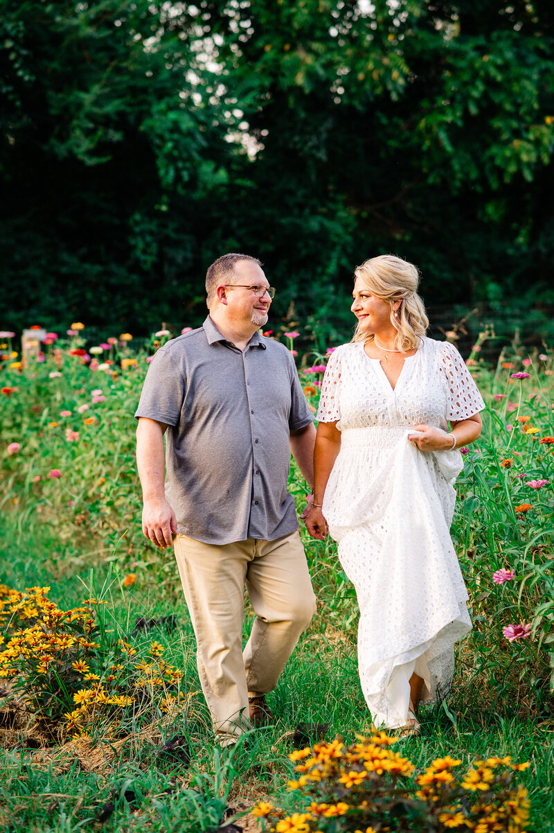 Newlyweds walking in flower garden