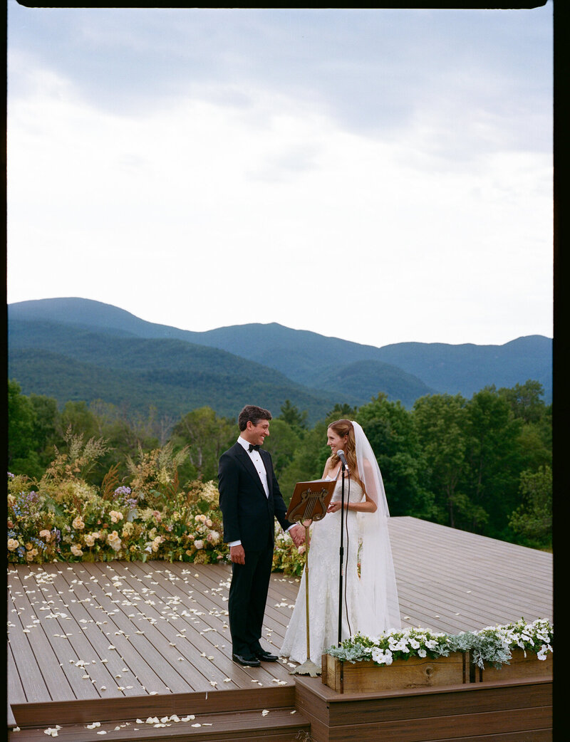 photo of bride and groom holding hands at von trapp family lodge taken by new york film wedding photographer