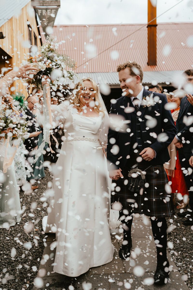 A confetti tunnel of chaos at The Free Company wedding venue