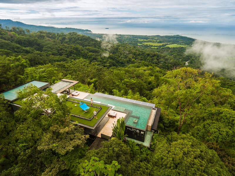 Infinity pool and grass lounge space in hidden Costa Rican jungle resort