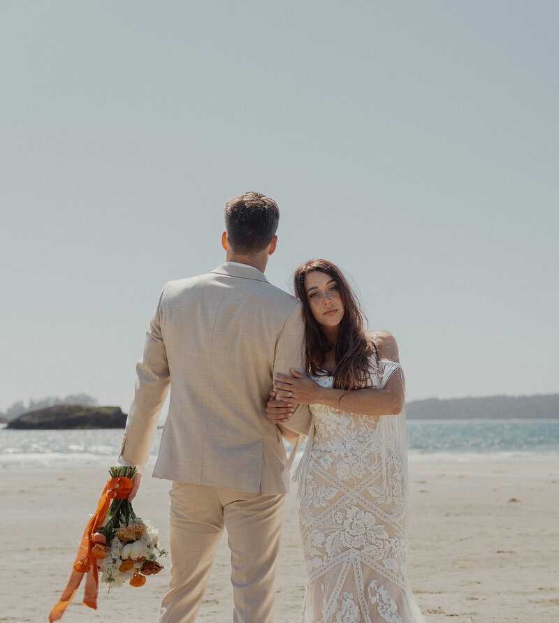 Engaged couple laughing together during a beach engagement session at Tofino, captured by Latitude 49 Photography.​