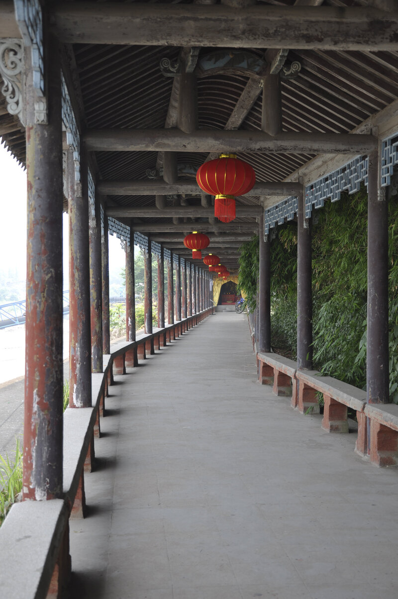 a walkway with paper lanterns