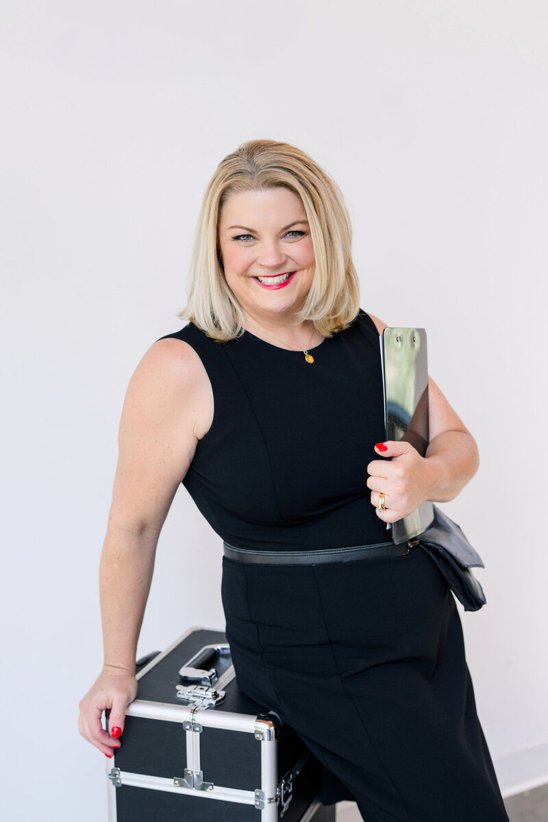 Austin TX wedding planner smiling with a clipboard in hand, ready to manage every detail with confidence and care.
