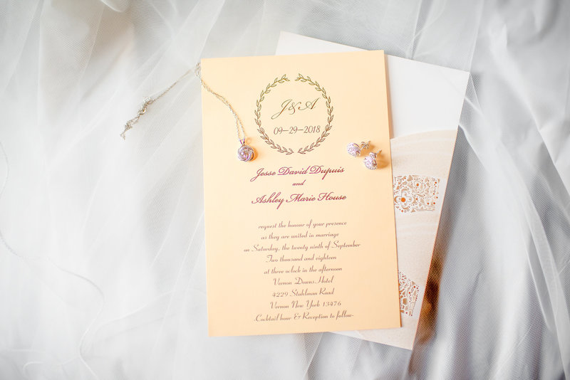 Picture of an invitation with jewelry on it
