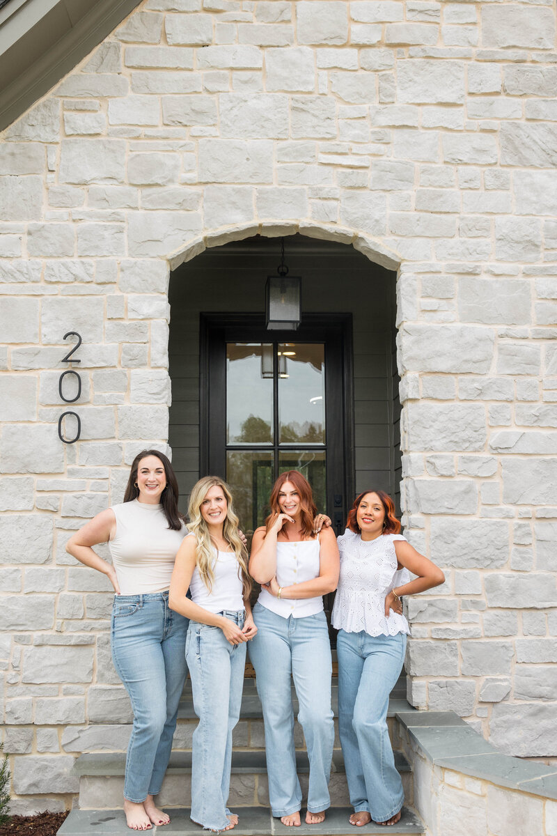 Fuquay Varina  Real estate agency, Jacie and Co, sitting on stairs.