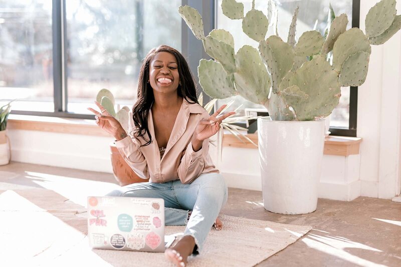 Woman posing with laptop on floor