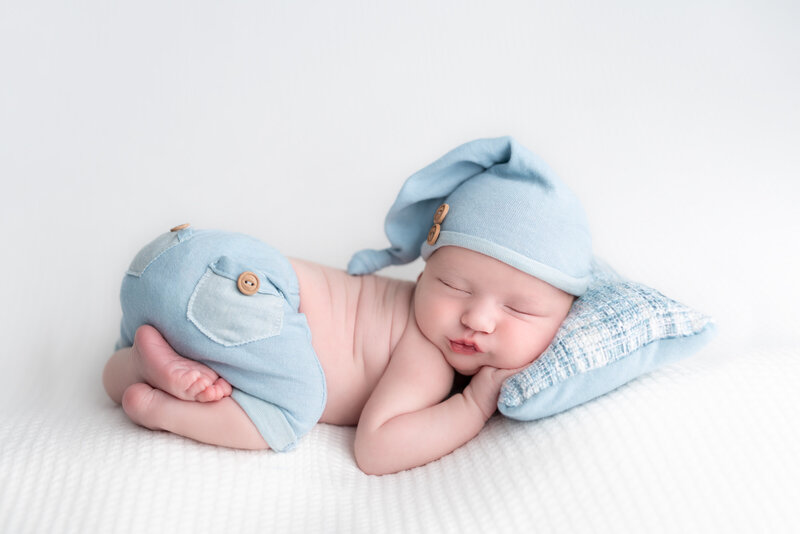 Dressed in denim and dreams – a baby boy posed in soft pastels.
