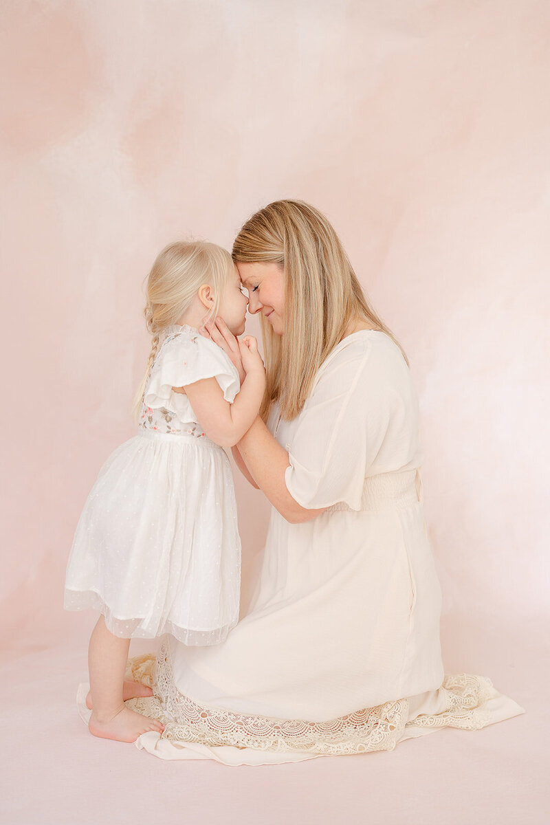 sweet mom and daughter moment during studio family photo in Gainesville, VA
