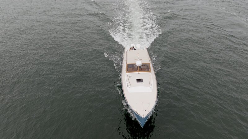 Bride and groom arriving to their wedding in boat in Maine
