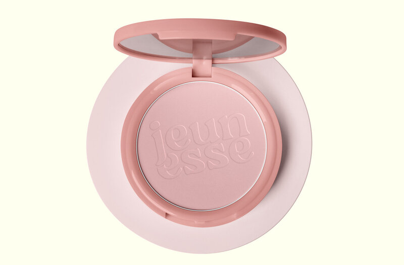 A pink compact with a logo that reads, "Jeunesse"