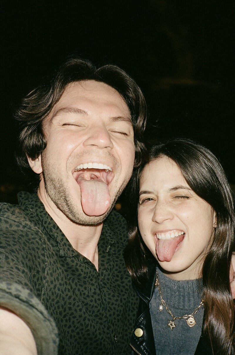 couple sticking tongues out at camera