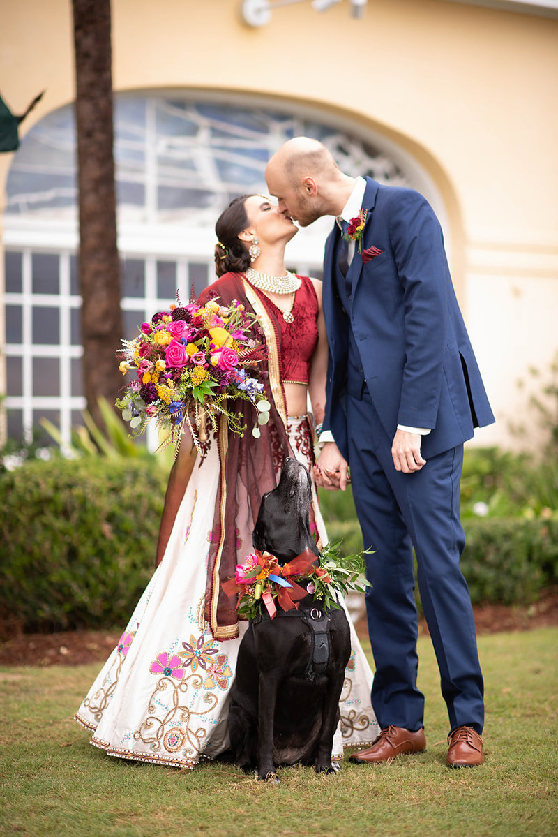 Dog poses for the couple at their wedding