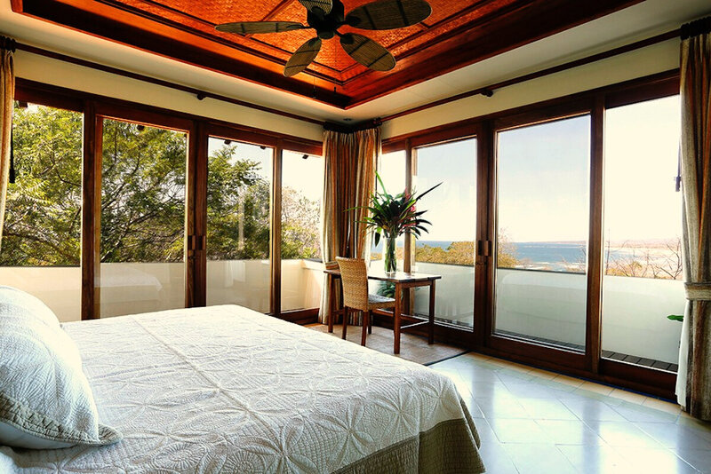 white bed facing glass doors superior ocean view room blue spirit costa rica