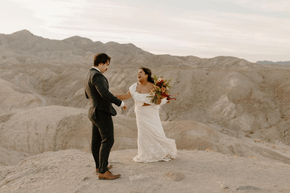 Bride and groom dancing in desert