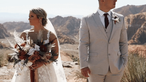 Bride and Groom hold hands for a video for their destination wedding in utah.