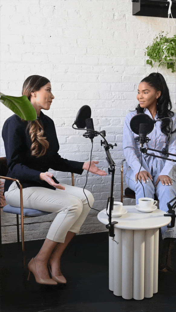 GIF of two women talking in microphone