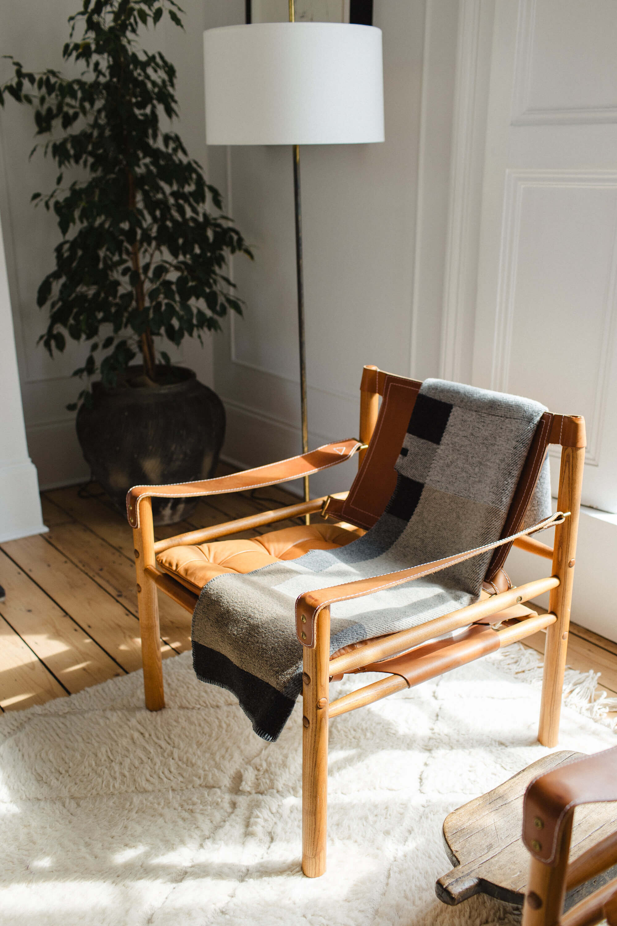 Leather slingback chair in white apartment