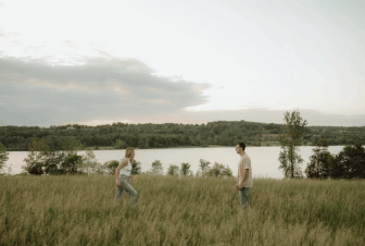 Couple running into each other’s arms in a field during a playful session in Doylestown, Pennsylvania