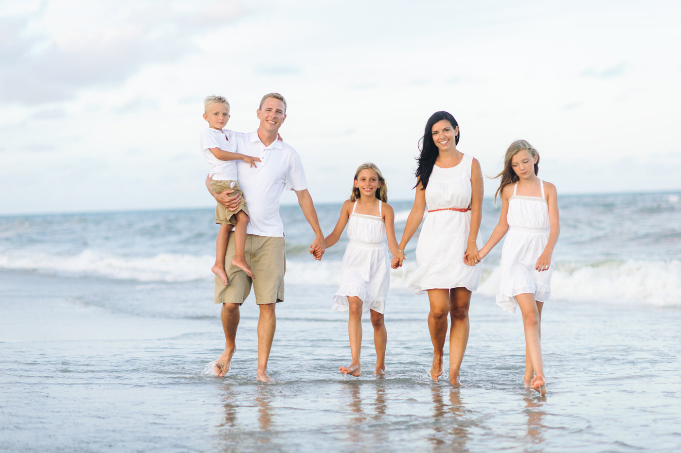 Myrtle Beach Family Photographer - Family holding hands during family beach portraits in Myrtle Beach 