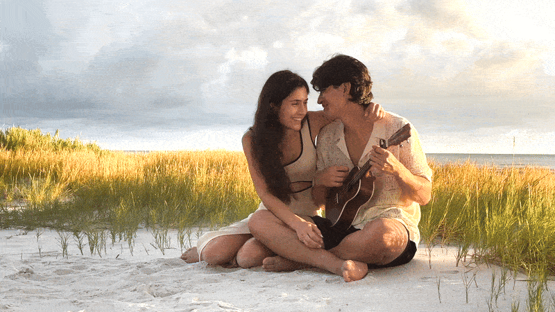 Moving gif of man playing ukulele and his new fiance laughing with him
