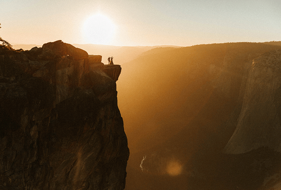 GIF of man spinning woman on the top of mountain
