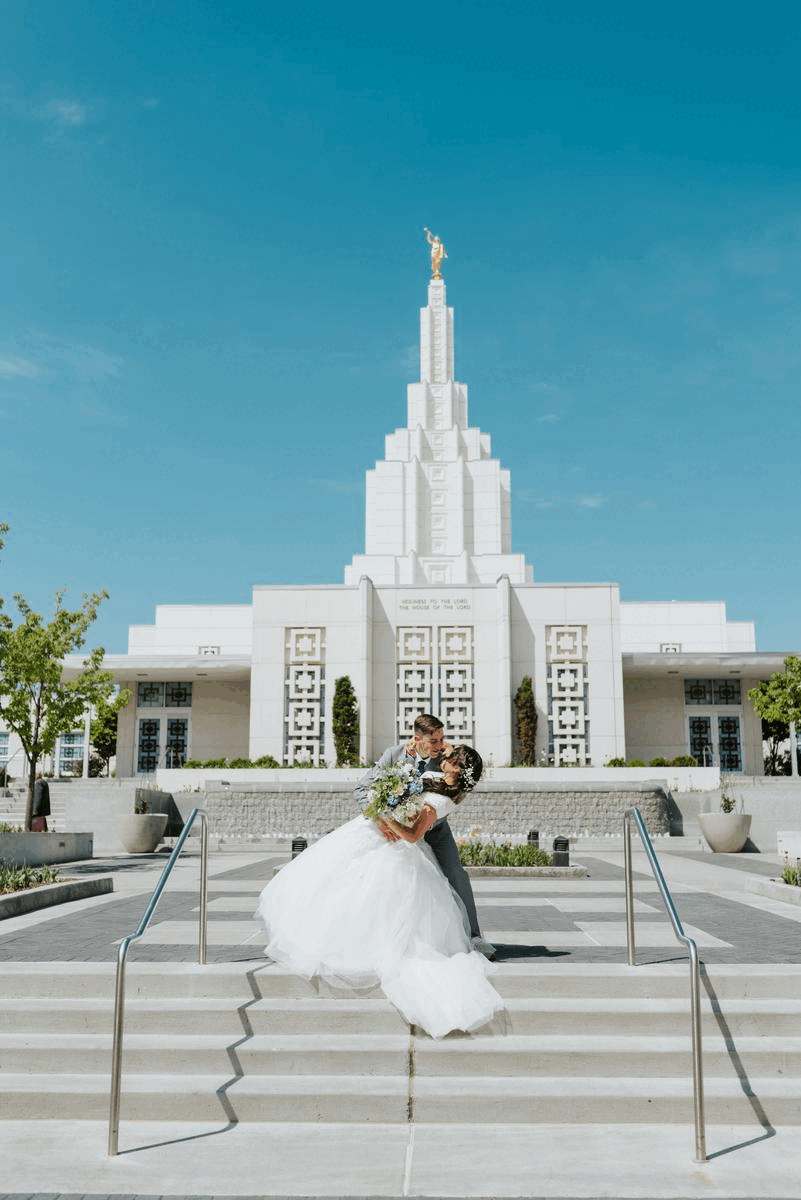 Newlywed couple kissing in front of the Temple after their Idaho Wedding