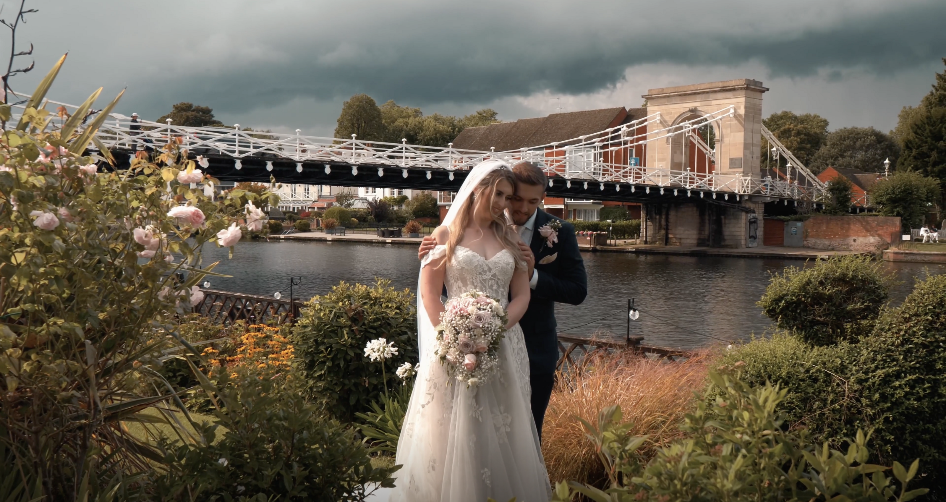 A couple have a tender moment together at the Compleat Angler, Marlow, Buckignhamshire. With the iconic Marlow backdrop behind them. 