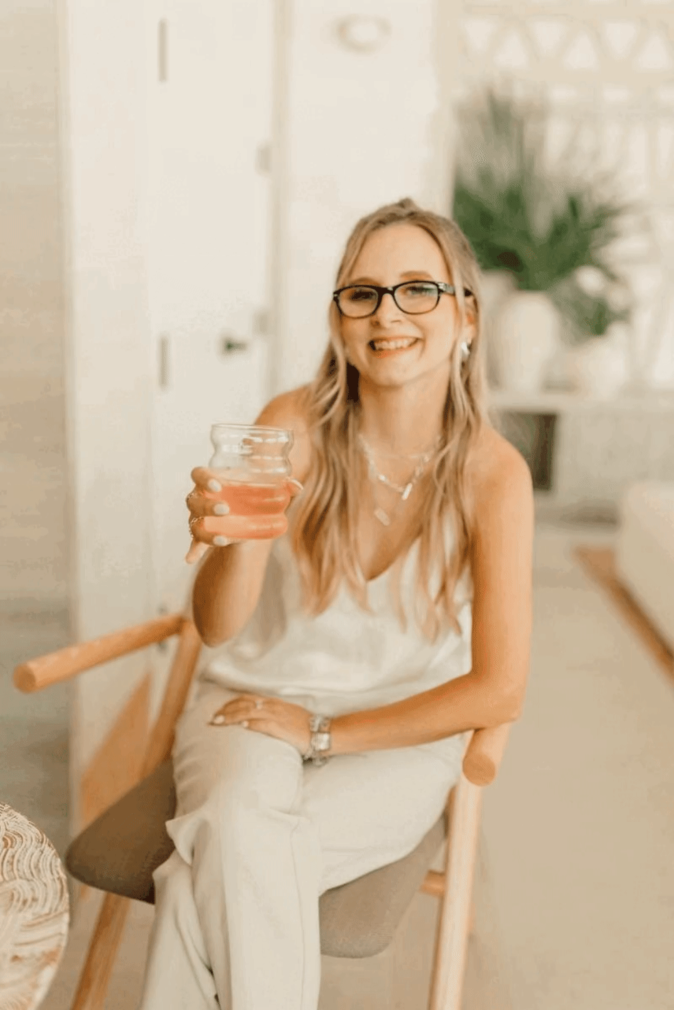 Woman smiling and cheers with a drink