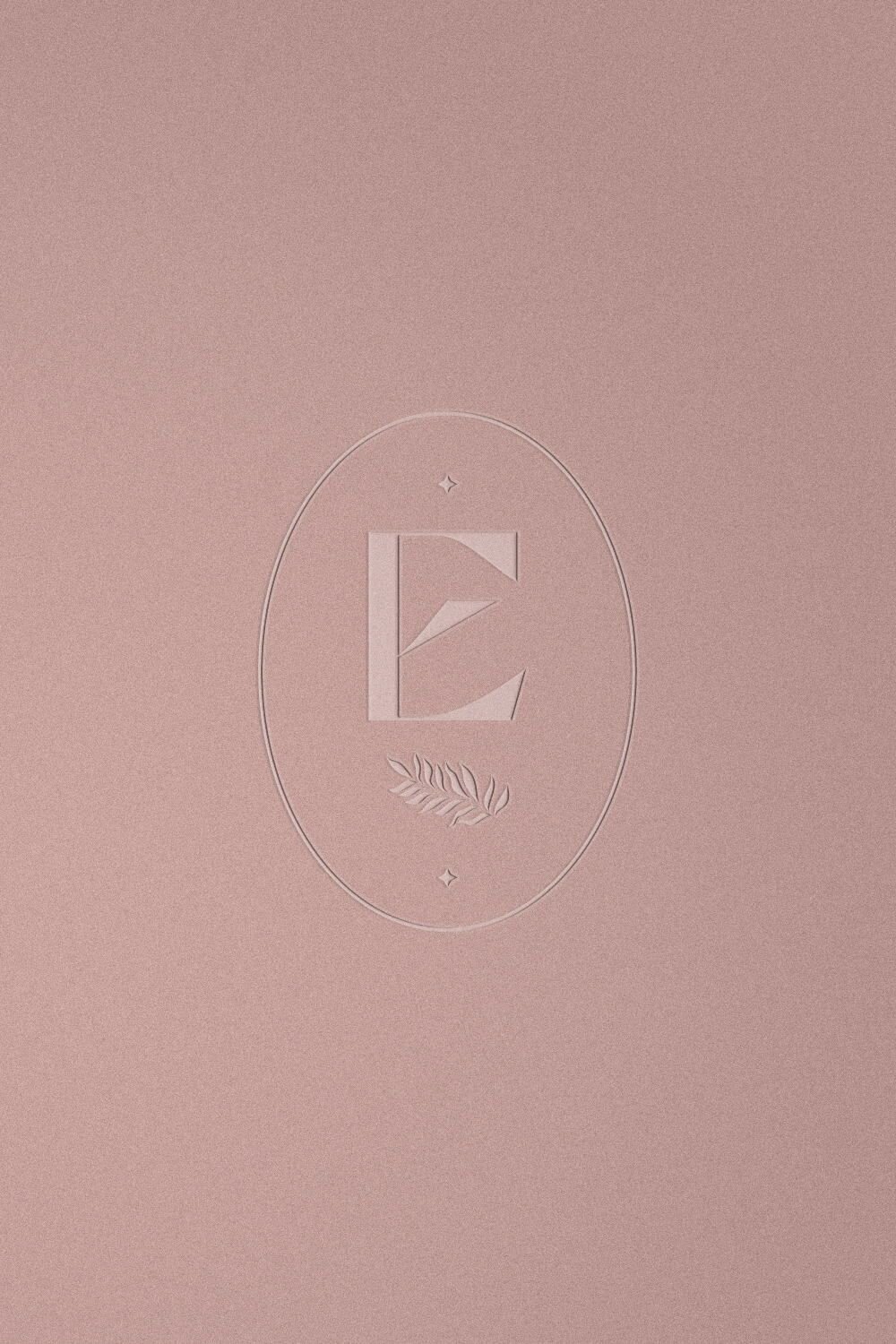 embossed submark logo of an e-commerce brand on pink paper