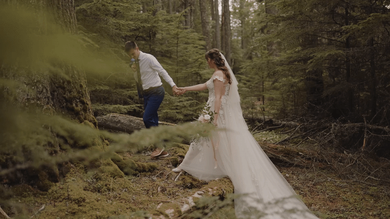 Couple walking in montana woods during elopement
