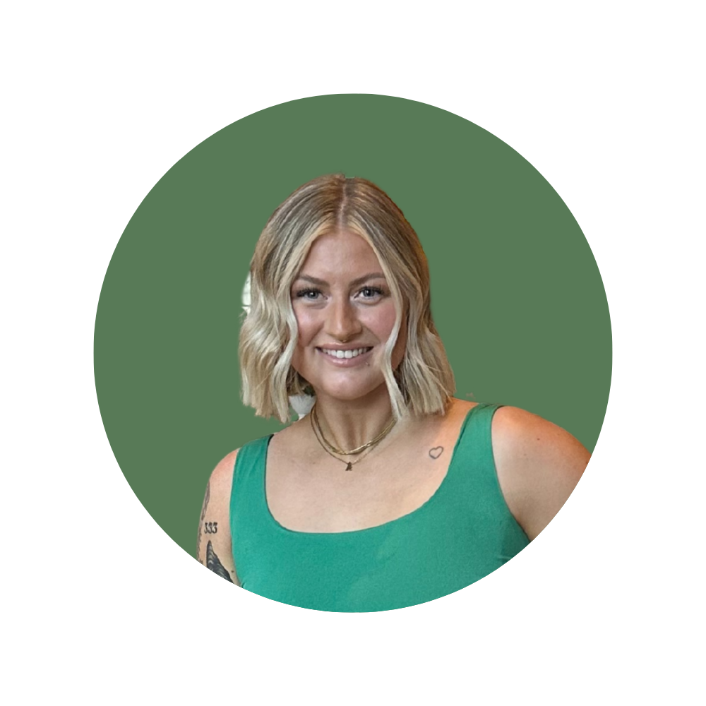 Danielle, a Web Designer Library member, smiling in a green tank top with short blonde hair.