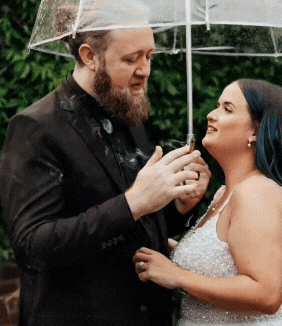 Couple Kissing Under Umbrella and Smoking