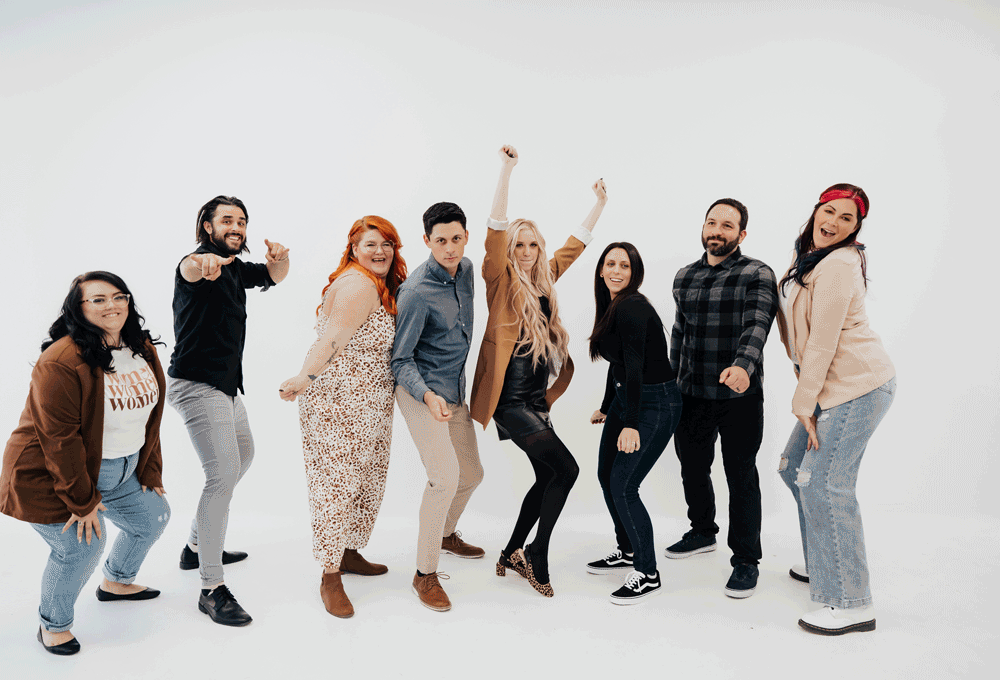 The Combs Creative team smiling and dancing then doing a group hug