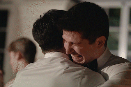 emotional groom hugging brother and crying