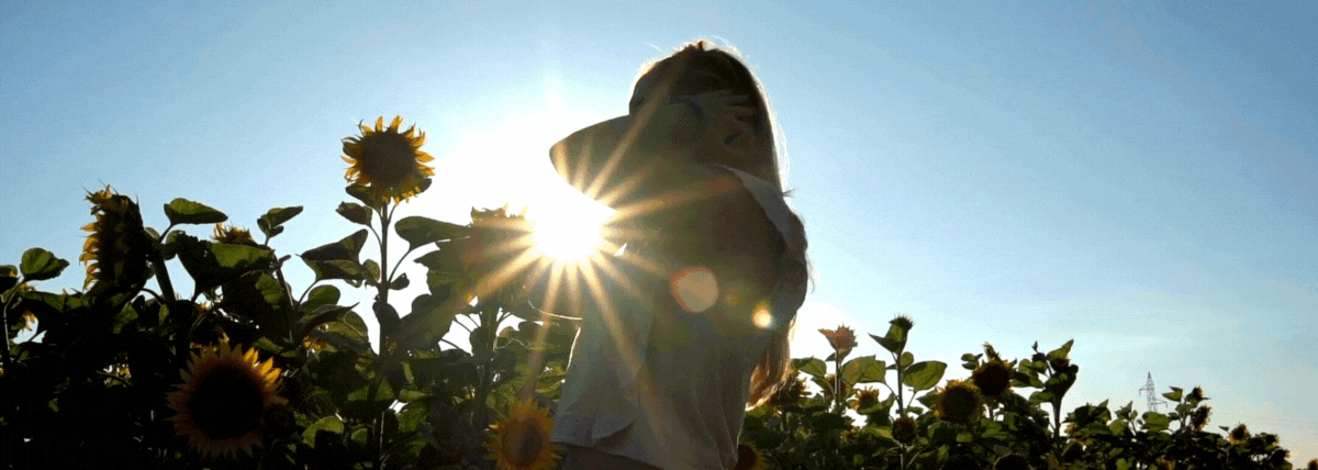 Woman spinning in sunflower field
