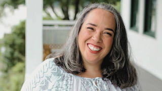 Smiling woman with gray hair on a porch