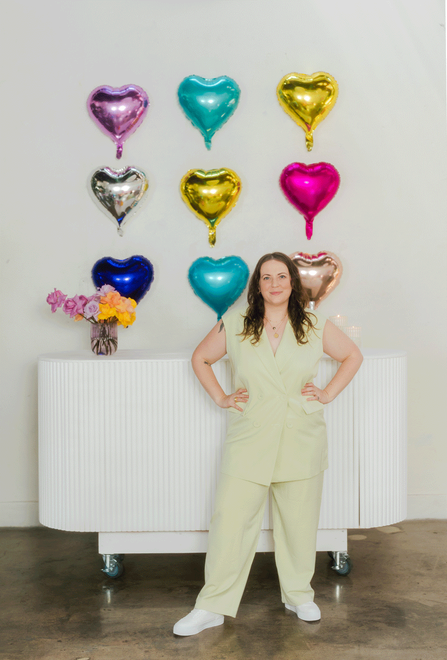 gif of a woman surrounded by colorful falling balloons