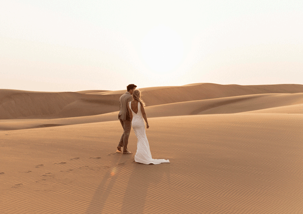 Lost in love amidst Namibia's moon-like magic, this newly engaged couple strolls hand in hand through an otherworldly landscape. A celestial journey into forever begins here