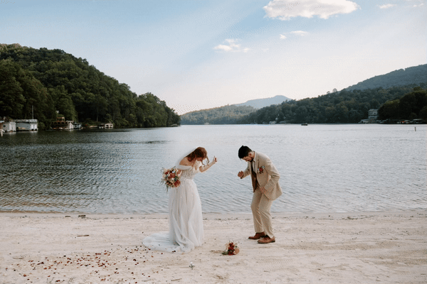 Bride and Groom dance Wes Anderson style on the side of a lake