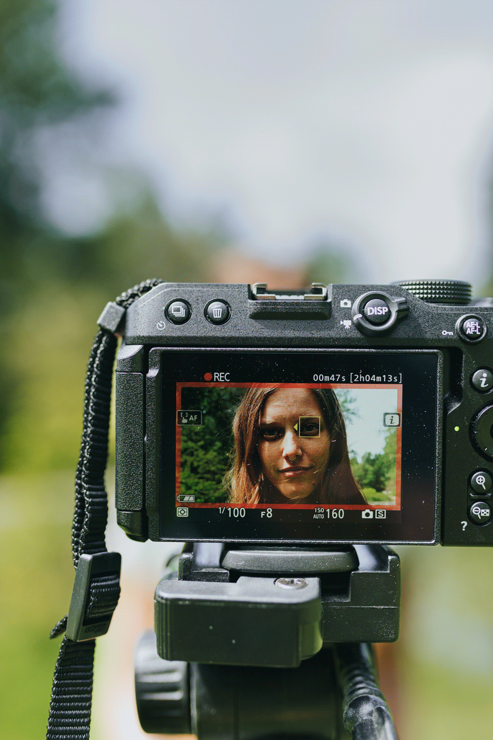 Gif of camera screen showing multiple images of woman posing.