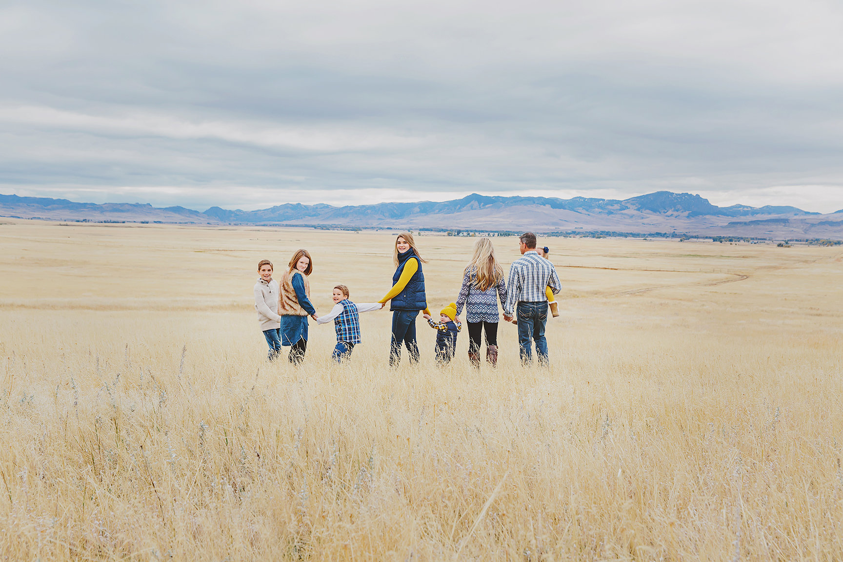 a family of 8 in a field showing fall colors, layers and testures