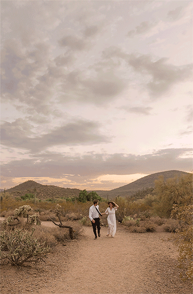GIF of eloping couple running through desert