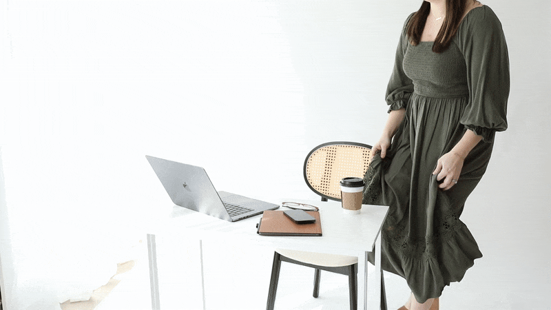 Computer and work related items scattered on the ground next to woman's leg