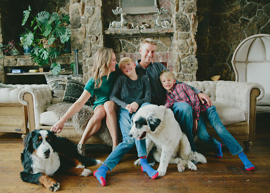 a family of 4 and their dogs in a in-home shoot