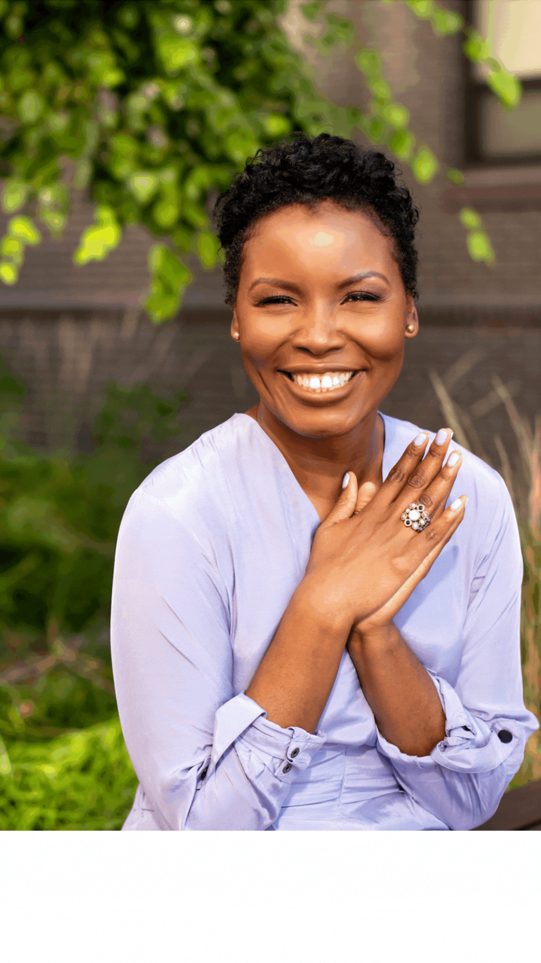 Smiling headshot of Marjorie Richard with greenery background