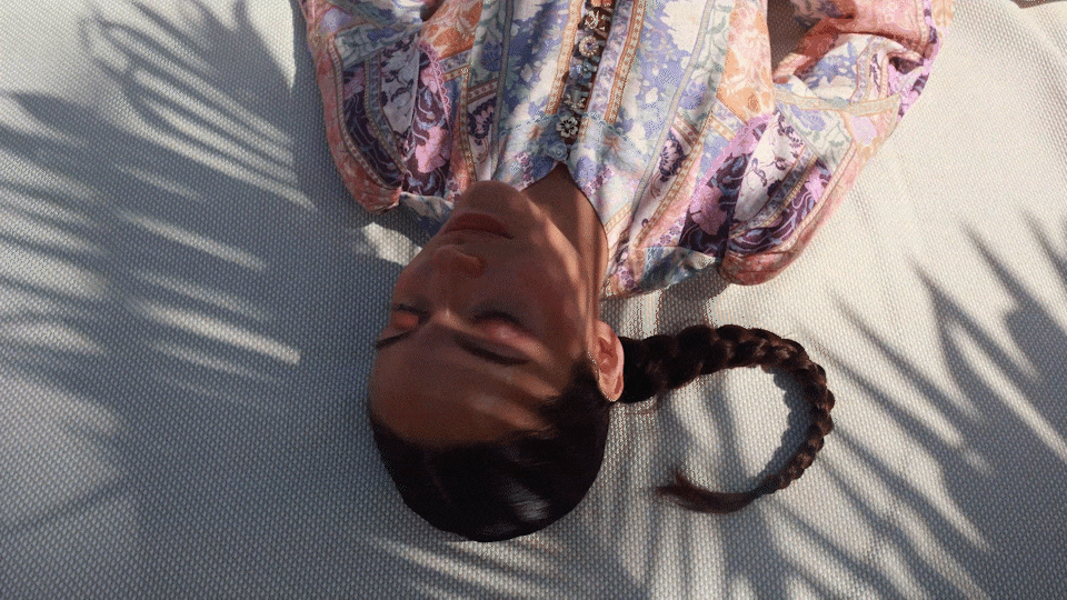 luxury photograph of woman laying at the beach