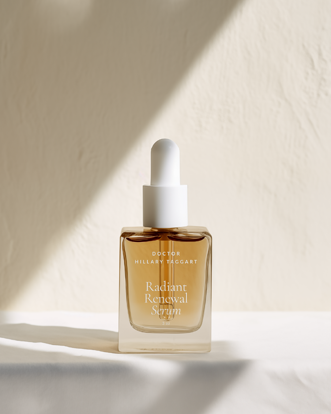 Radiant Renewal Serum bottle in warm amber tones with Dr. Hillary Taggart’s branding, styled in soft natural light.