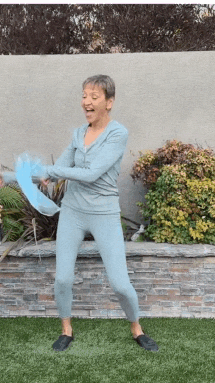 Melinda Fornero dancing with a pink and blue scarf