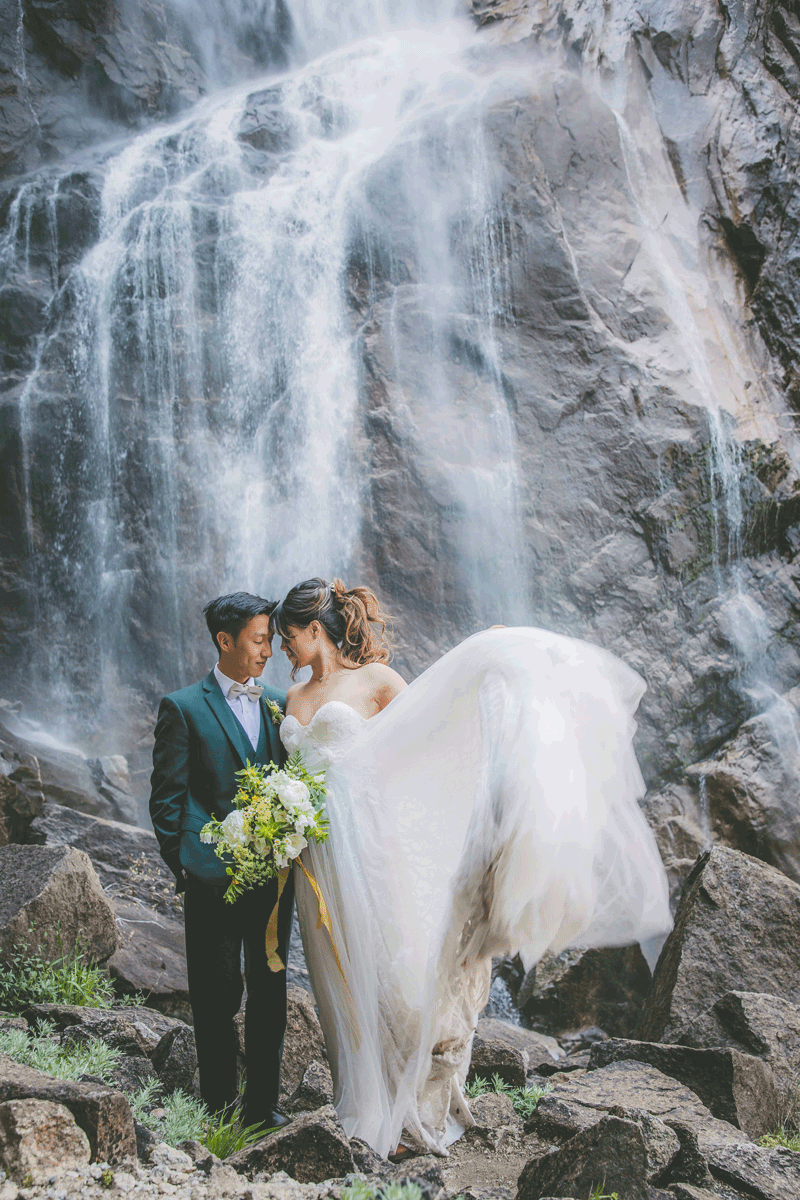A gif animation of a bride and groom close together and she flips her dress up in Yosemite.